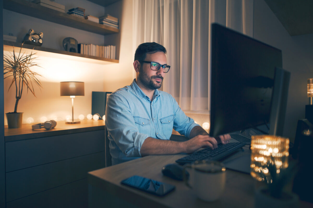 Picture of a person working on a computer at home